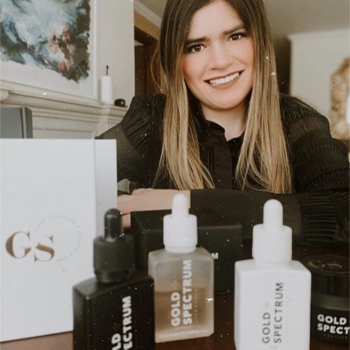 A young lady with her Gold Spectrum CBD products 