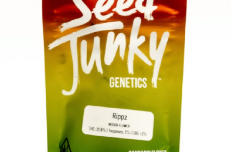 The Rippz Strain from Seed Junky Genetics pictured packaged in an ounce size of Red, Yellow, and Green sealable baggie.