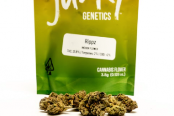 The Rippz Strain from Seed Junky Genetics pictured packaged in an ounce size of Red, Yellow, and Green sealable baggie.