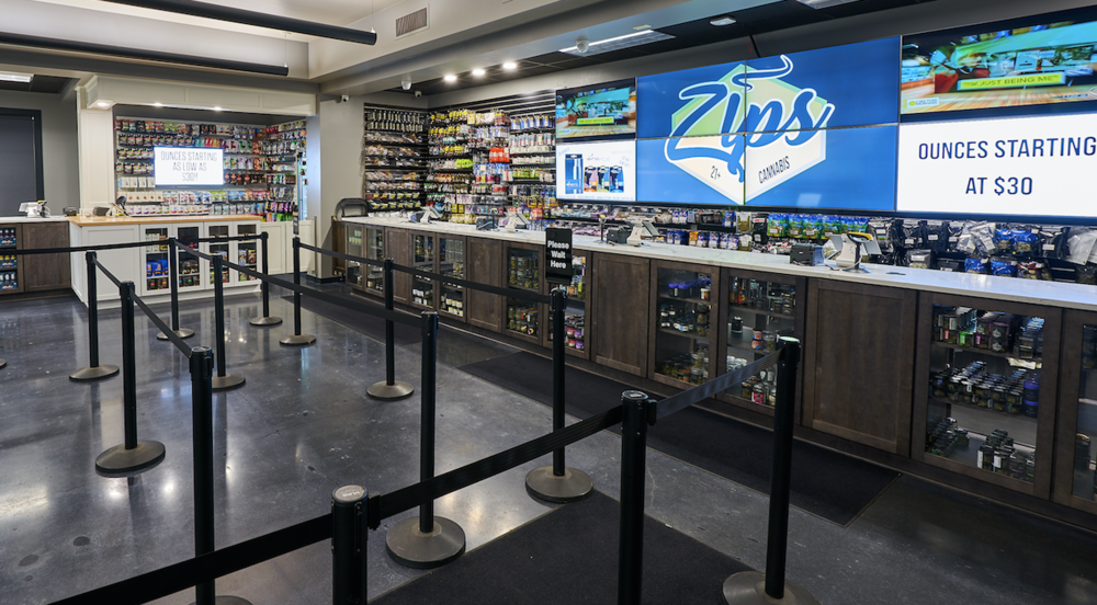Inside zips cannabis tacoma dispensary, a long counter with a wide selection of products