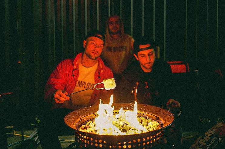 Jordan, Sam, and Jimmy making s'mores for Unemployed