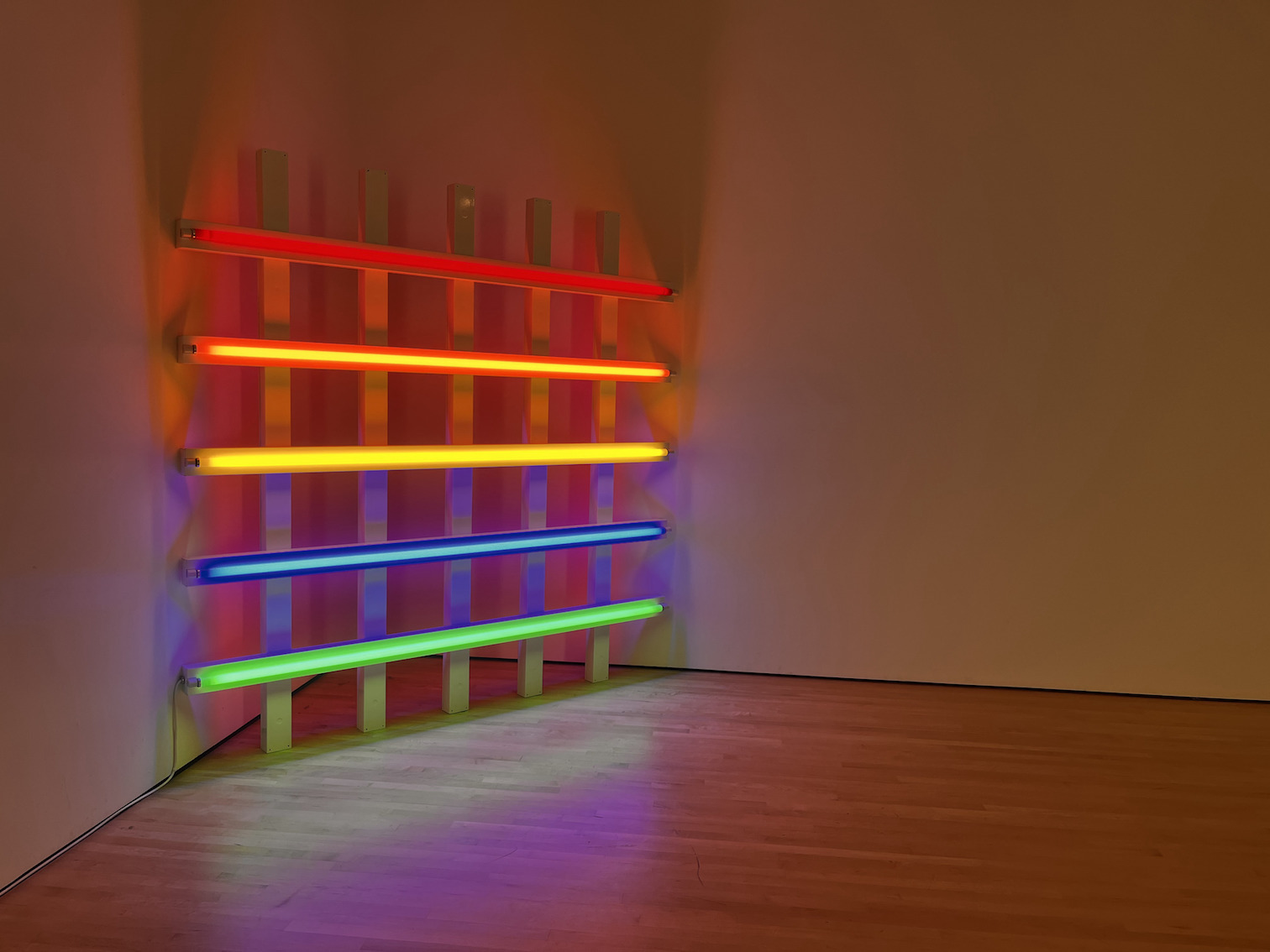 Disability Accessibility at SFMOMA.
Dan Flavin's Untitled. A gridded rainbow neon light sculpture, illuminating a corner of the room.